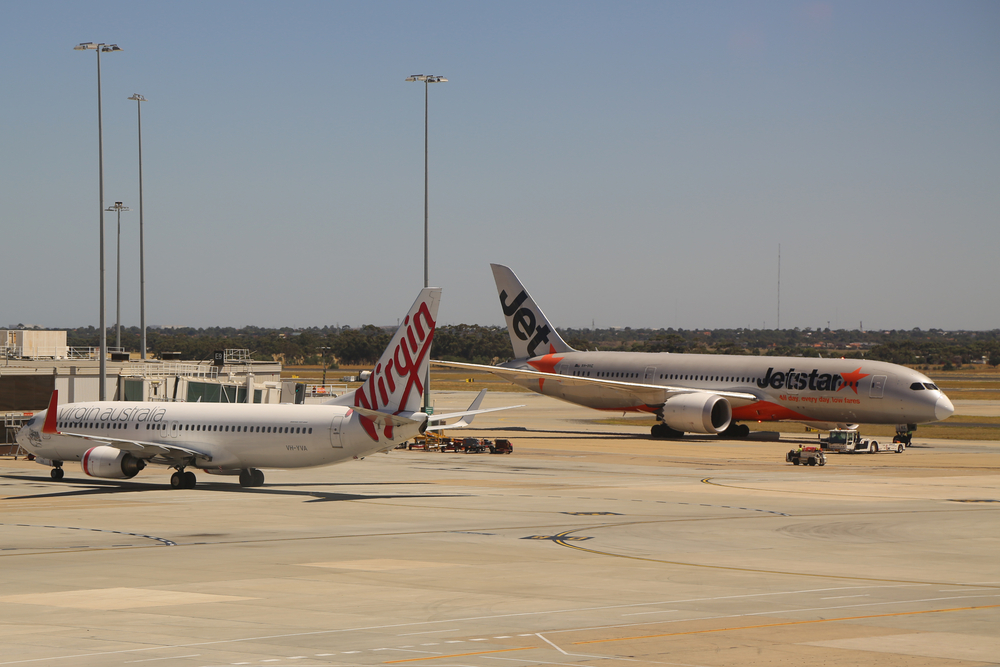 Planes on a tarmac representing Virgin & Jetstar two domestic airlines of Australia one option to come explore Tasmania